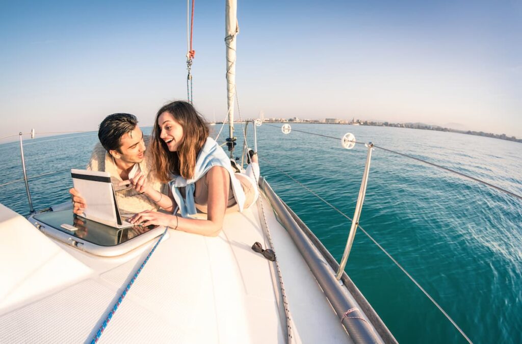 couple on a sailboat in Barcelona in July