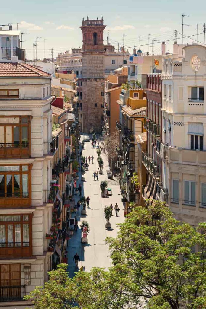 a street in Valencia with people walking