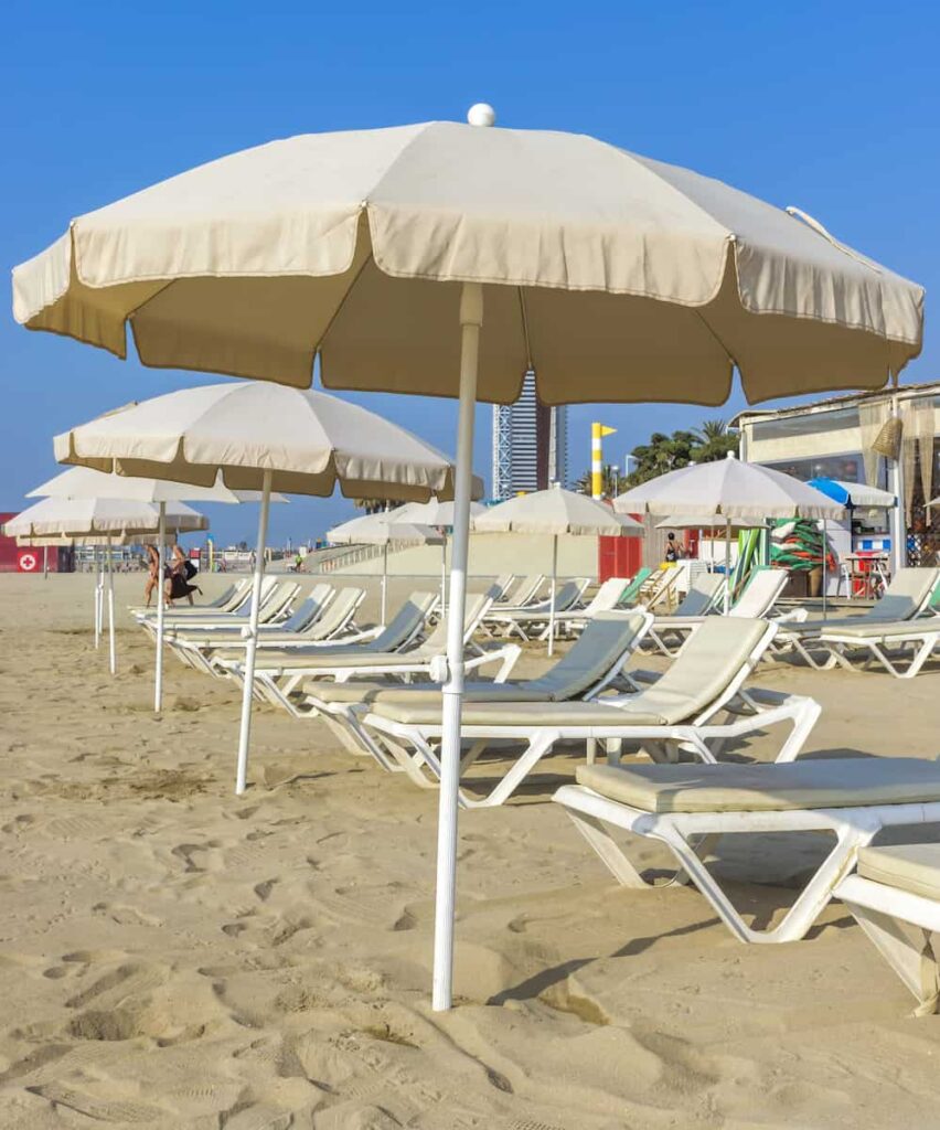 umbrella and chairs at Barcelona beach 
as what Barcelona is known for