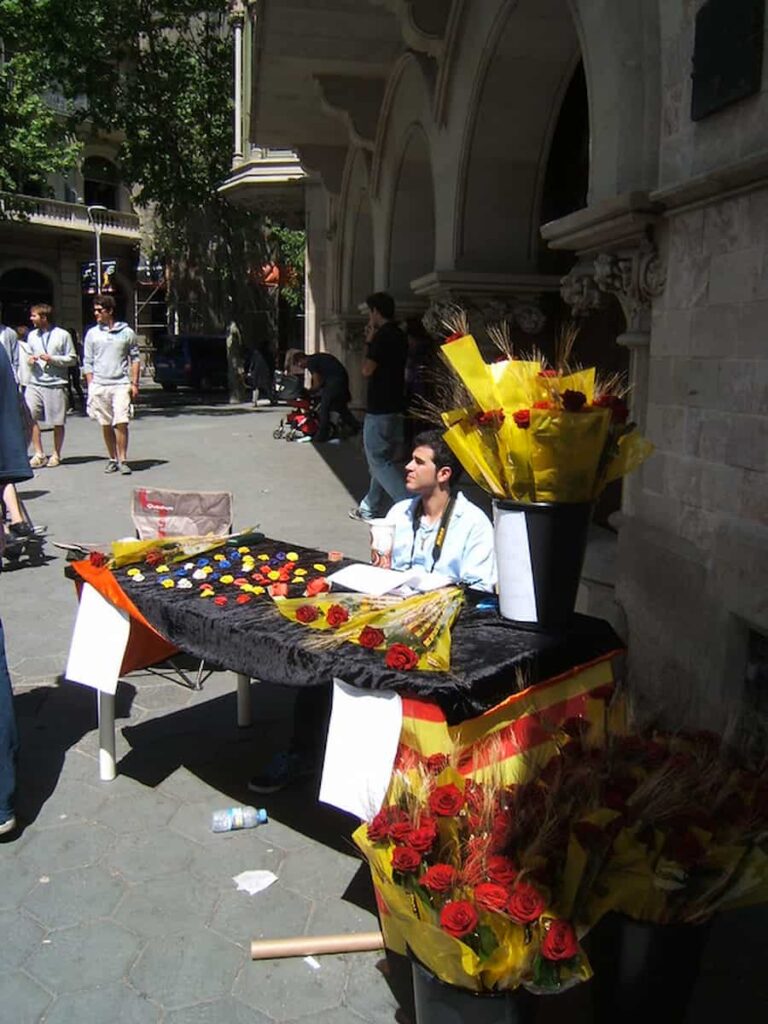 a man selling flowers as the city celebrates El Día de Sant Jordi (St. George's Day) in Barcelona in April