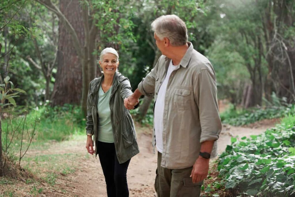 elderly couple doing hiking an activity that you can do if you are retiring in Valencia