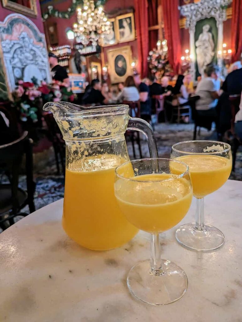 a pitcher and 2 glasses of Agua de Valencia