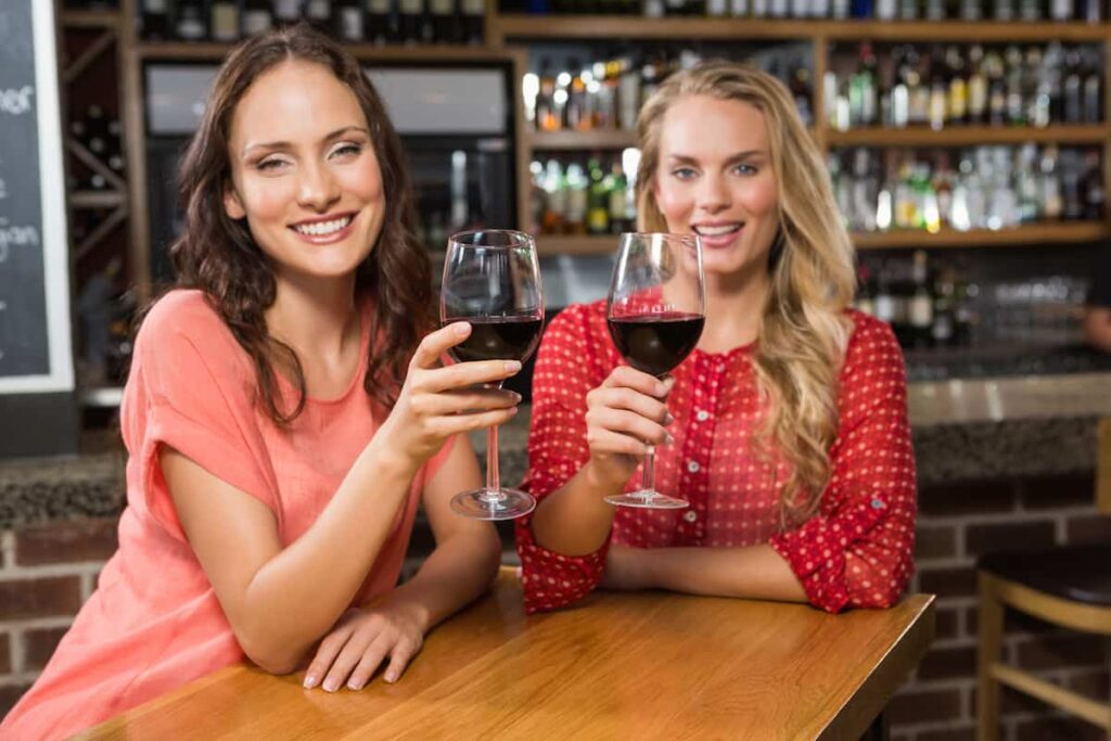  two women having a glass of wine

