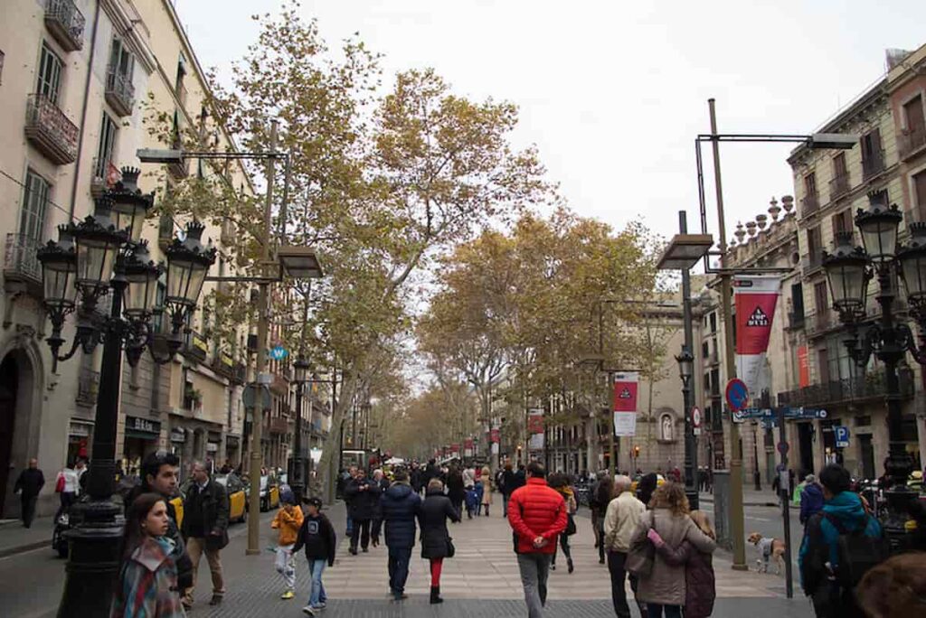 La Rambla, Barcelona's iconic boulevard, enthralls visitors with its vibrant atmosphere, lined with bustling shops, lively street performers, charming cafes, and a captivating blend of local culture and international flair.