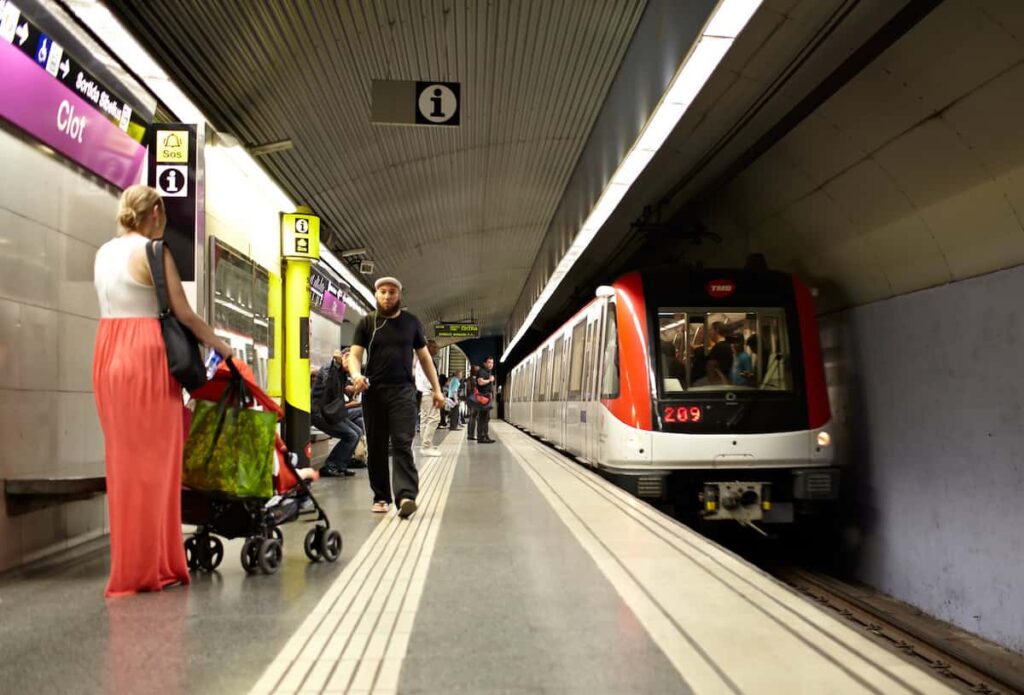 Passengers wait for the train in barcelona metro map