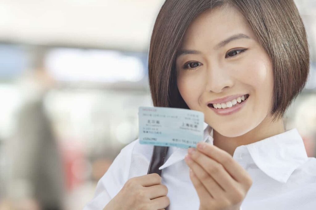 Young Woman Looking at a Train Ticket