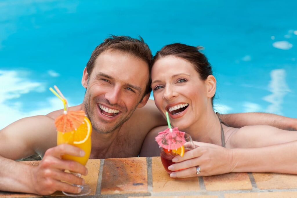 These couple is relaxing in the pool while having drinks in Go! Beach Club. One of the best beach club in Barcelona.