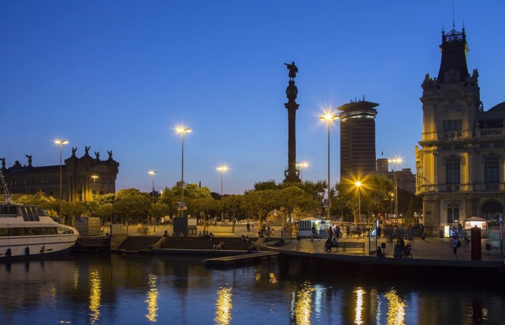Columbus Monument (Monument a Colom) and the waterfront to Port Vell (Placa del Portal de la Pau) at the south end of Las Ramblas in the Old Town district of Barcelona in the Catalonia region of Spain. One of the best to visit in Barcelona night tours.