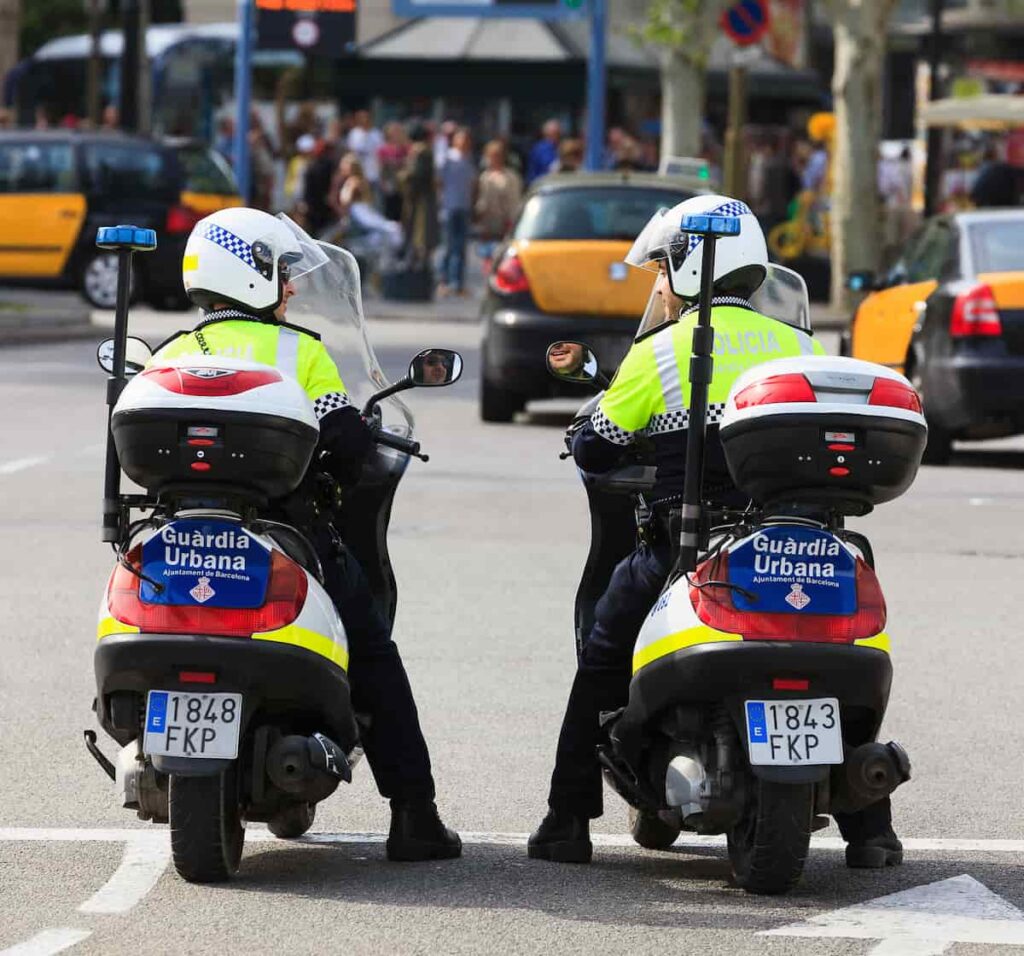 Policemen on bikes watching the crowd at the Plaza de España, one of Barcelona's most important squares. And you will think is Barcelona safe?