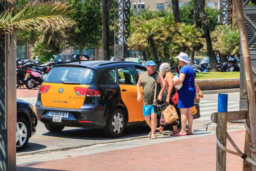 Tourists ride in a taxi near the beach. One of the best reason in question is the Barcelona safe?