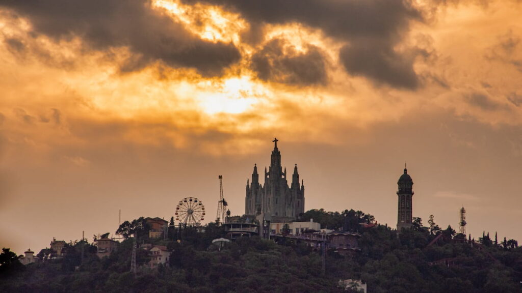 Sunset over Barcelona's Tibidabo Amusement Park is one of the best places to visit in Barcelona at night.