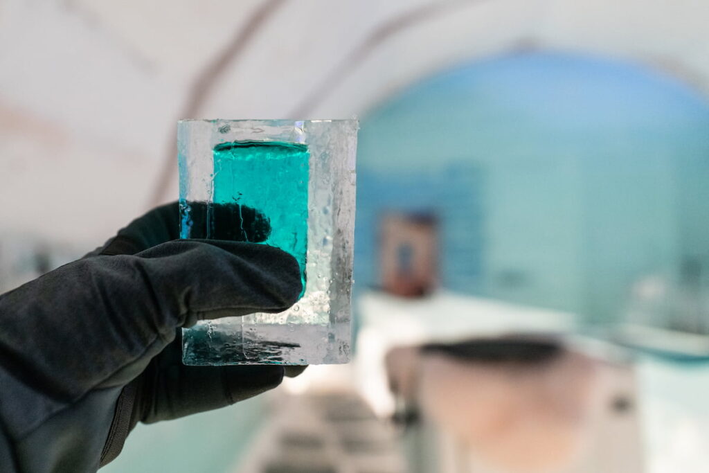 Visit the Ice Bar like these guy who holds a liquor while wearing a gloves is one of the best places to visit in Barcelona at night.