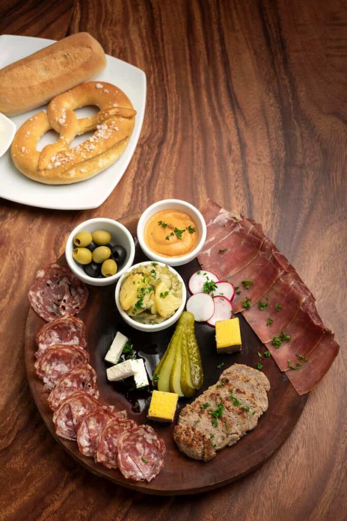 Cold cuts tapas snack platter with meats and bread is one of the main menu in Bar La Plata. One of the best Tapas in the Gothic Quarter Barcelona.