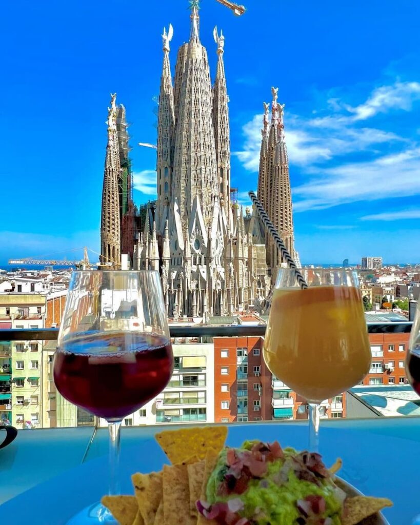 a glass of sangria and juice with the view of Sagrada Familia in one of the 4 star hotels in Barcelona