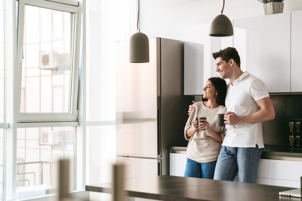 couple in the kitchen of one of the best aparthotels in Barcelona in the city center with a pool