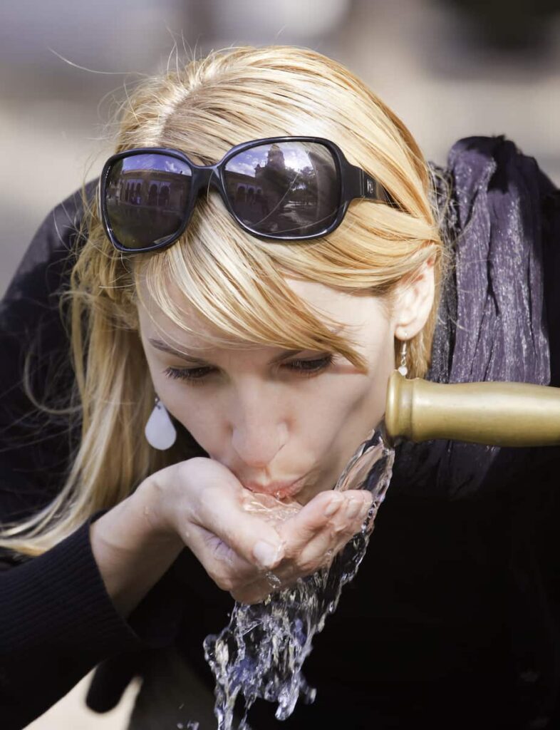 These lady is drinking tap water in barcelona.