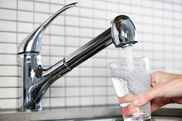 person getting drinking water wondering is Barcelona tap water safe to drink
