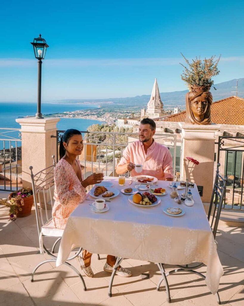 couple having breakfast table with a rooftop view in barcelona vacation rentals