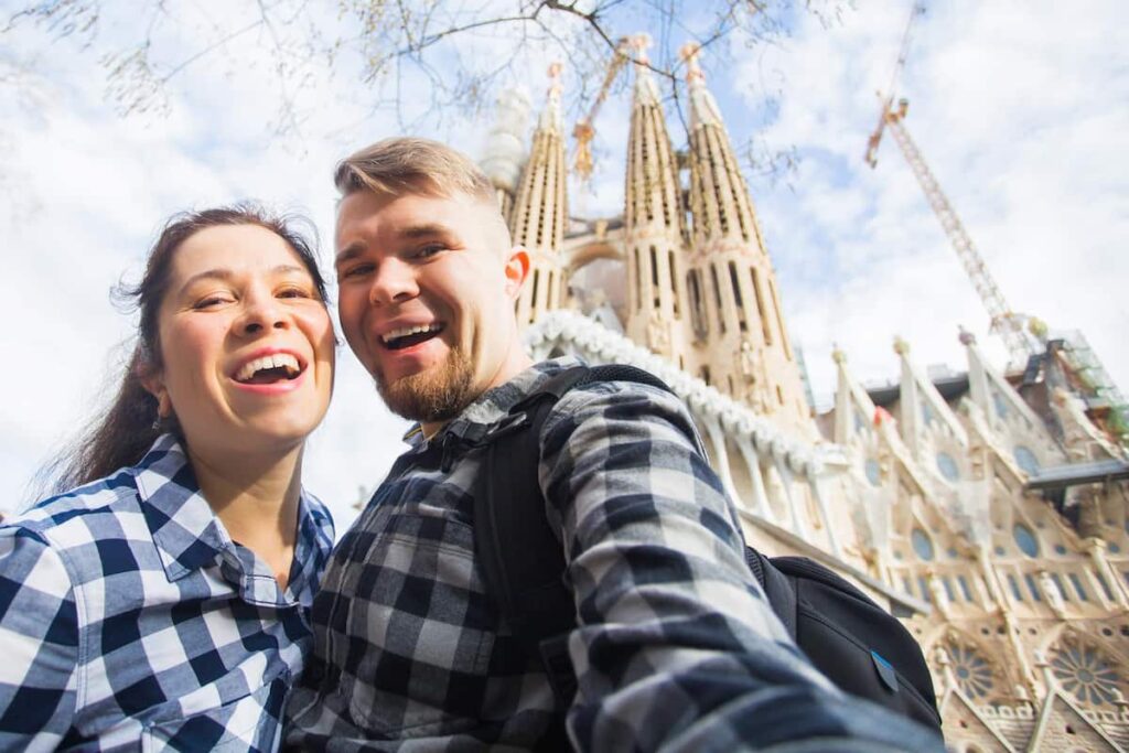 These couple is taking selfie in front of the Sagrada Familia before going inside.