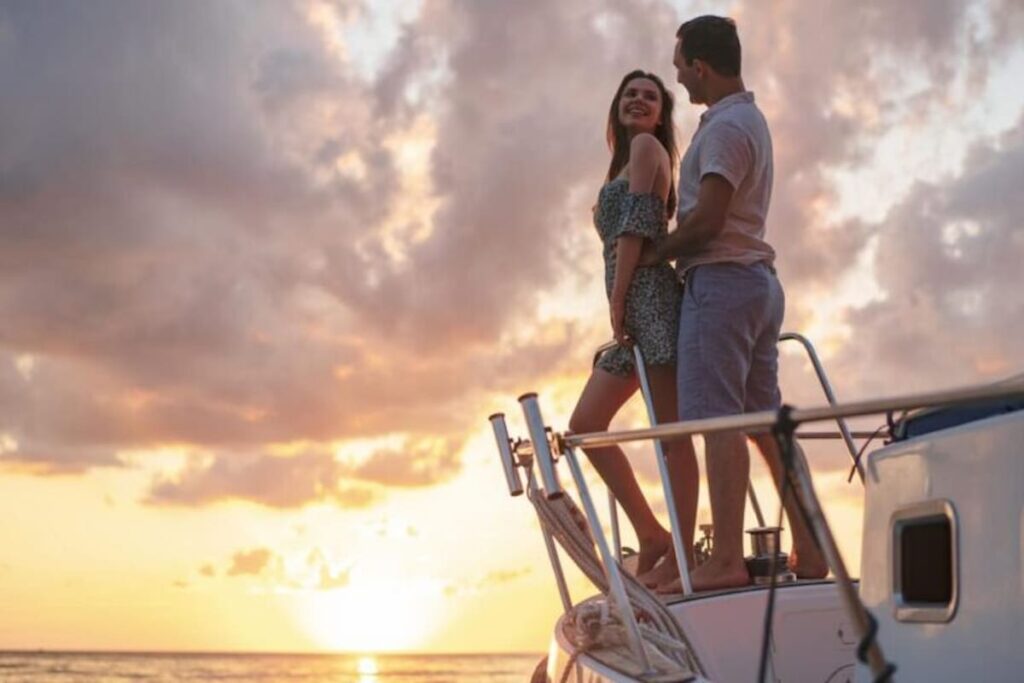 a couple enjoying a sunset sailing tour