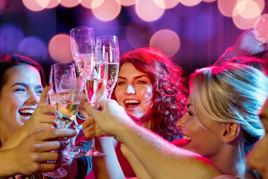 Group of girls making a toast of wine while partying in the Poble-Sec.  One of the best areas in Barcelona nightlife.