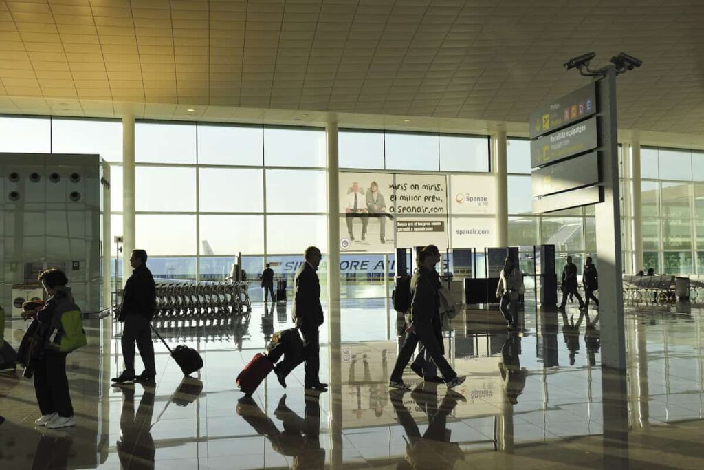 Passengers move inside famous El Prat airport of Barcelona by early morning.