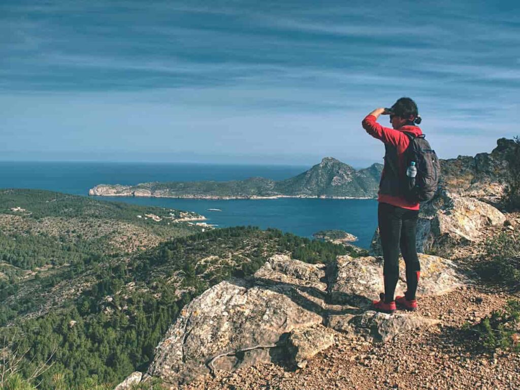 Woman traveller in the island of Cala Formentor. One of the best islands near Barcelona.