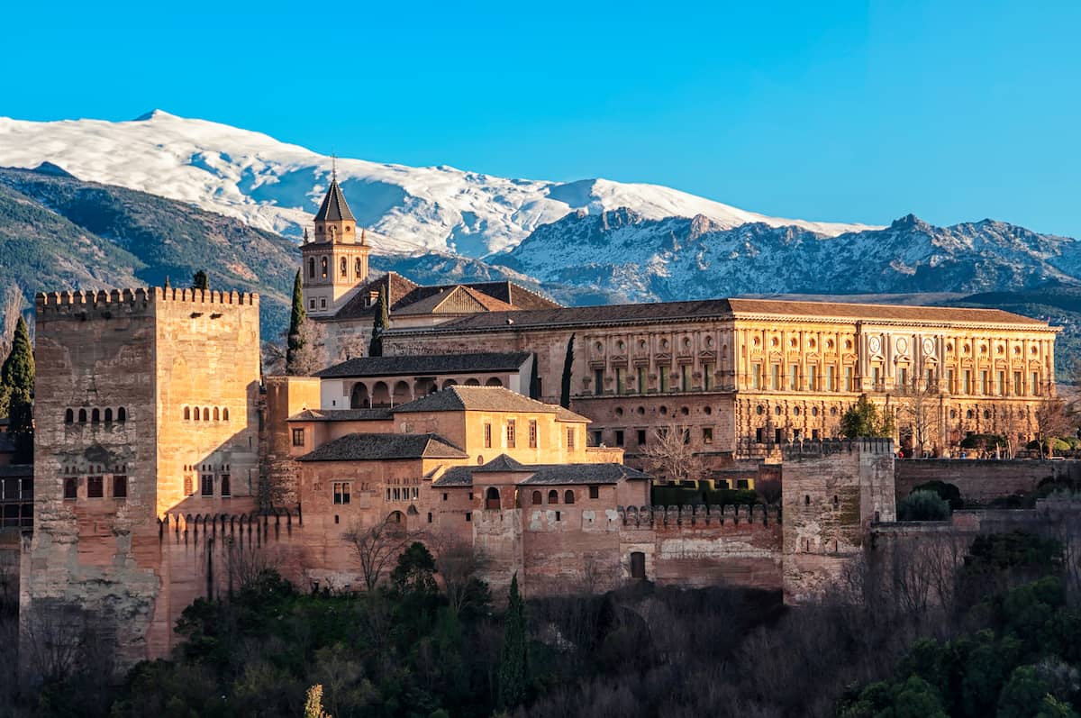 Alhambra with snowy mountains behind it showing an example of the weather in Spain in January
