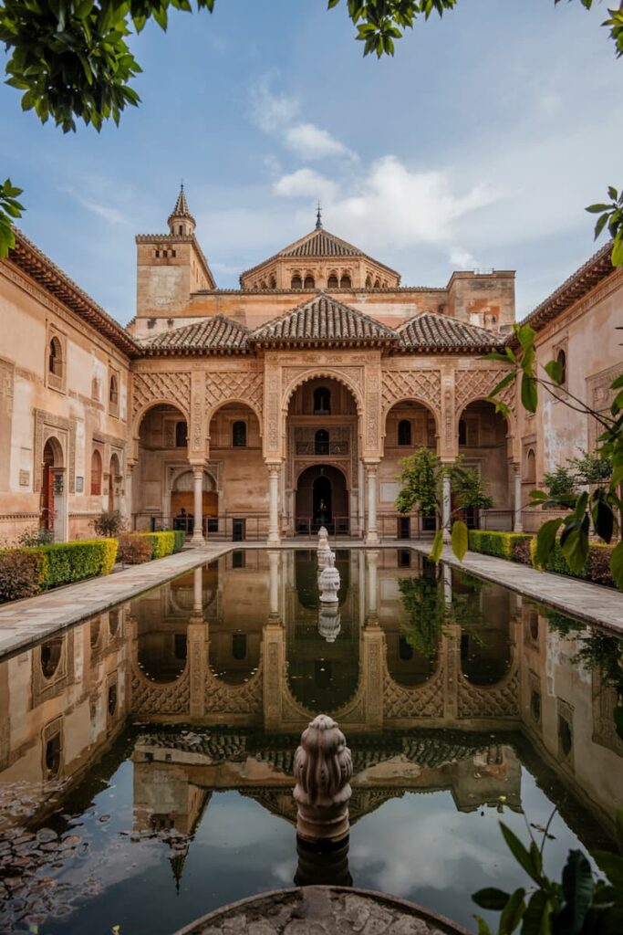 Reflections in the still water of the Court of the Lions at the Alhambra in Granada, one of the top places to visit on a one week itinerary through southern Spain