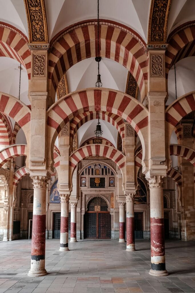 Striped arches and columns inside the Mosque-Cathedral of Córdoba, an iconic stop on a one week itinerary in southern Spain