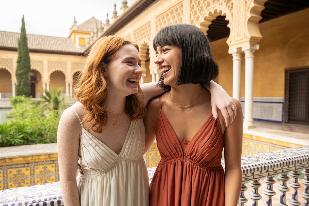 Friends laughing together at the Real Alcázar in Seville, capturing joyful moments on a two-week southern Spain itinerary
